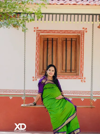 A peaceful solo portrait of the mother-to-be seated on a rustic swing, embodying tranquility and grace.