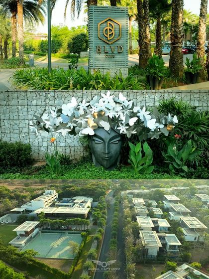 A view of the BLVD CLUB entrance signage and unique art installations, combined with an aerial shot of the villas and grounds.