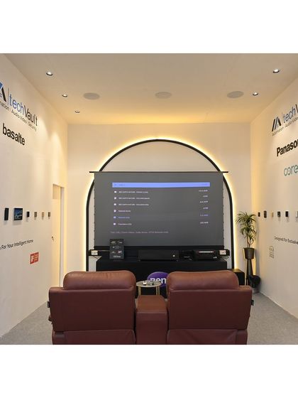 The home theatre experience area within our exhibition booth. We set up a demonstration with a large screen and premium recliners to give visitors a firsthand feel of the cinematic quality we can create.