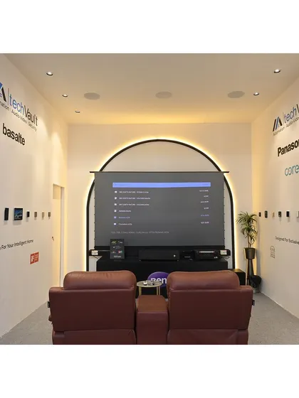 The home theatre experience area within our exhibition booth. We set up a demonstration with a large screen and premium recliners to give visitors a firsthand feel of the cinematic quality we can create.