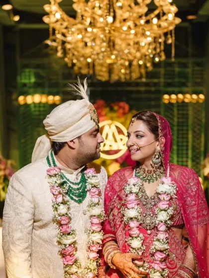 A classic portrait of the couple under a grand chandelier, capturing the opulence and romance of their special day at the JW Marriott.