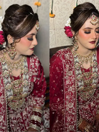 A closer look at the bridal hairstyle my team created. This elegant updo is adorned with fresh red and white flowers, perfectly complementing her maroon outfit and adding a touch of softness to the overall regal look.