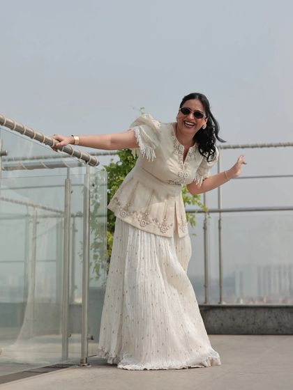 A candid, happy moment captured during a Haldi carnival on a sunny rooftop. This is me in my element, enjoying the celebration just as much as the guests.