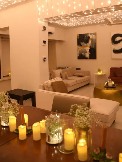 Another view of the 'Glimmer & Dinner' setup, showing how the fairy light canopy and candlelit table transformed the entire living and dining space into a cozy, romantic haven.