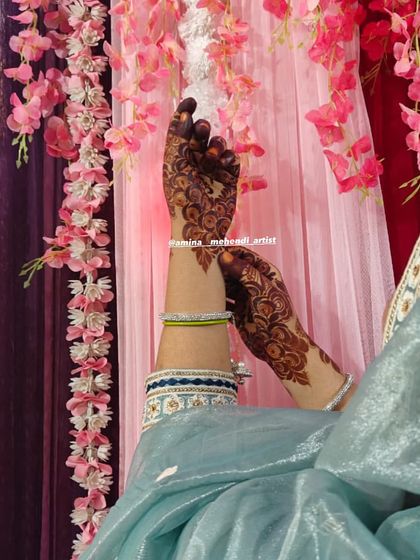 A side view of the party mehendi, showing how the design looks with traditional bangles.