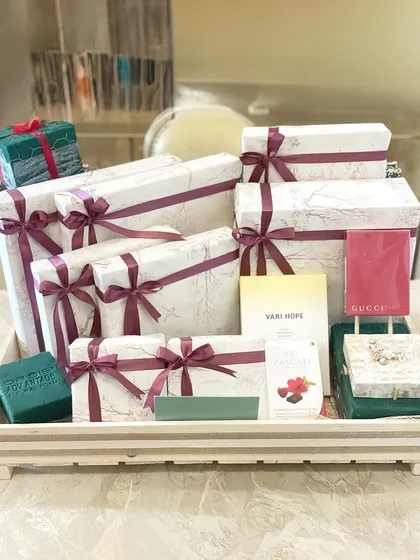 This hamper is filled with beautifully wrapped gift boxes in a white marble and burgundy theme, ready to delight any recipient.