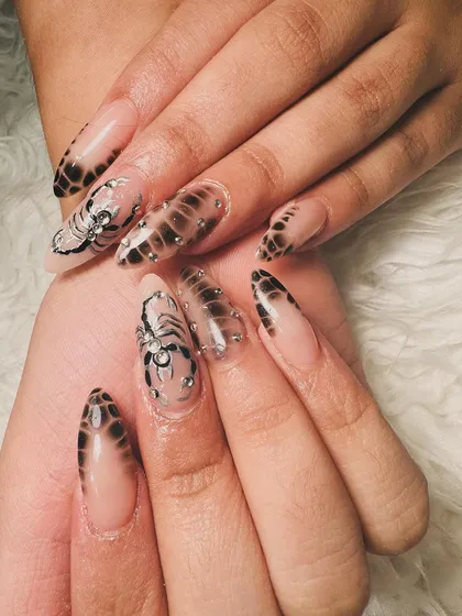 A closer look at the incredible detail on these scorpion and snakeskin nails.