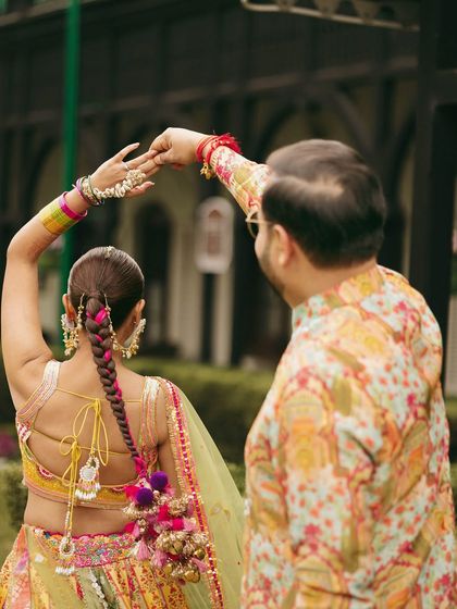 A beautiful shot from the back, showing off the intricate parandi braid and the colorful details of her lehenga.