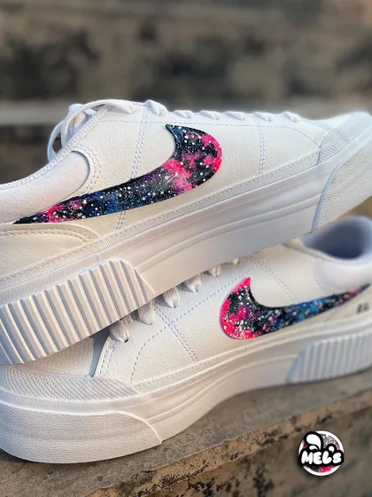 A stacked view of the galaxy swoosh sneakers, showing the vibrant pink and blue cosmic pattern.