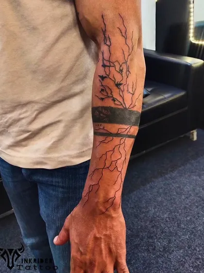 A full forearm sleeve depicting a lightning storm. This abstract piece uses bold black bands and chaotic lines to capture the raw power of nature.