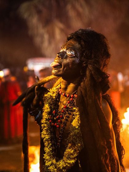 A devotee channels a deity, their expression and posture conveying a state of spiritual trance during the high point of the Kulasai festival.