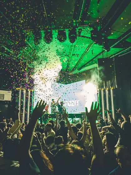 Locked in and zoned out, letting the music speak. This view from the console, with confetti raining down on a sea of hands, is unbeatable.