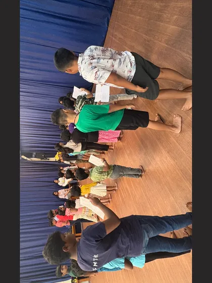 A candid moment from a script reading session. Students are learning to analyze characters and practice their lines, a fundamental part of our character-building curriculum that improves reading comprehension and public speaking.