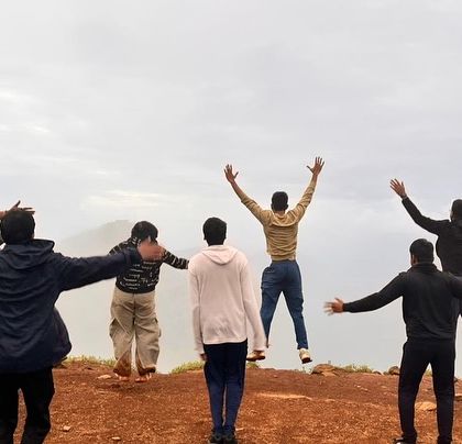 Pure freedom! A group jumping for joy at a scenic spot in Chikmagalur.