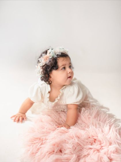 This eleven-month-old looks off to the side, creating a lovely candid-style portrait during her milestone session.