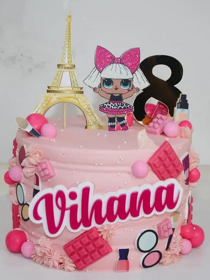 Pretty in pink for Vihana's 8th birthday! This LOL Doll-themed cake is decorated with edible makeup, chocolate bars, and a Paris Eiffel Tower topper.