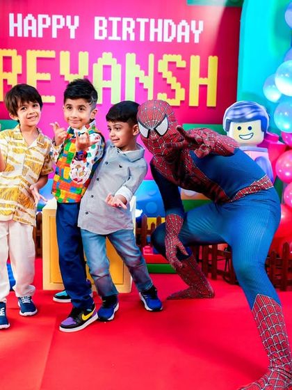 Spiderman makes a special appearance at this LEGO party, posing with the birthday boy and his friends.