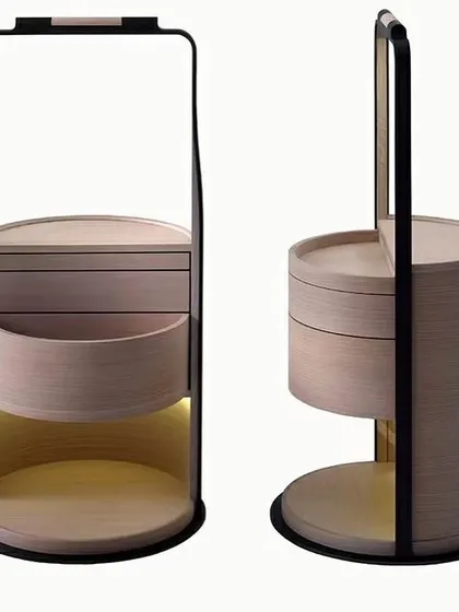 A unique and highly functional bedside companion. This piece features revolving trays and drawers in oak veneer, a metal frame, and integrated warm LED reading and night lights.