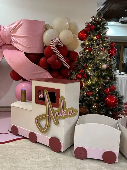 Anika's Christmas train, personalized with her name, served as a wonderful prop and a place to hold gifts, adding to the festive magic.