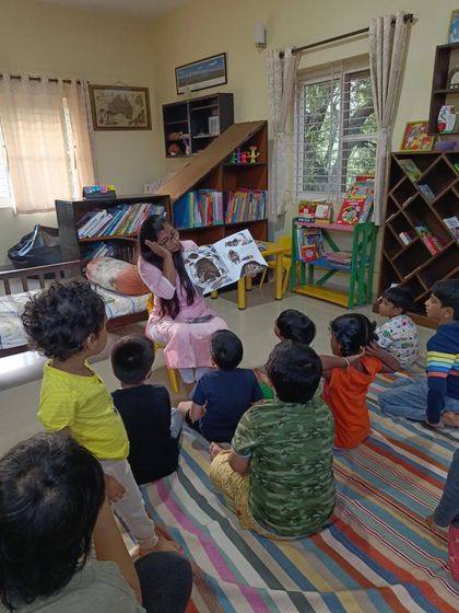 The storyteller shows a picture of a bear, her gentle tone making even a potentially scary animal seem friendly.