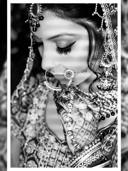 A classic black and white bridal portrait that emphasizes emotion and detail. This timeless style focuses on the bride's expression and the intricate patterns of her nath and henna.