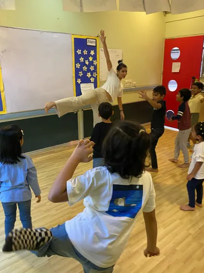 A dynamic movement exercise in progress. We use physical activities to help children connect with their bodies, express energy, and learn spatial awareness.