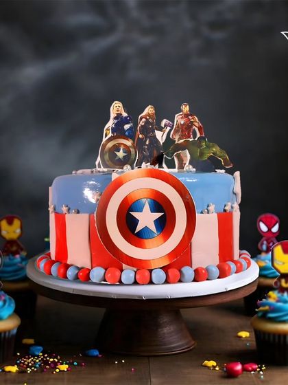 Avengers, assemble! This cake features Captain America's shield and a team of heroes ready for action, complete with matching superhero cupcakes for the ultimate party spread.