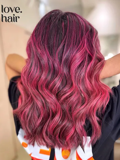 Pink is definitely our favorite crayon. We created this vibrant pink balayage with a mix of deep and bright pink tones for a multi-dimensional, fun look.