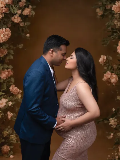 A romantic and intimate portrait of the couple, framed by a floral arch. The way they look at each other is a testament to their love story.