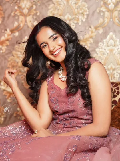 Another happy portrait, showing the soft curls and the elegant pearl necklace.