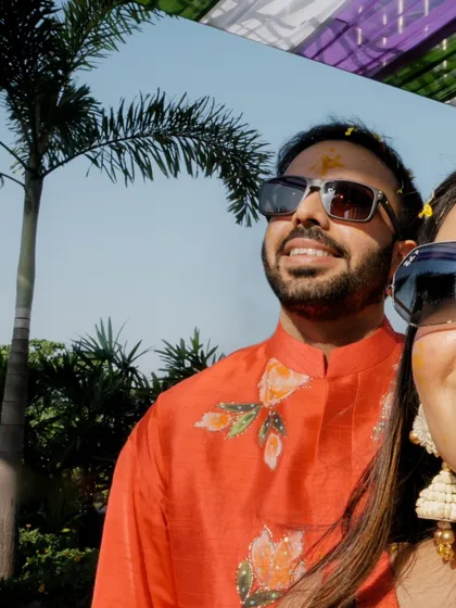 A cool and casual selfie-style shot of the couple during their outdoor haldi, capturing their relaxed and happy vibe.