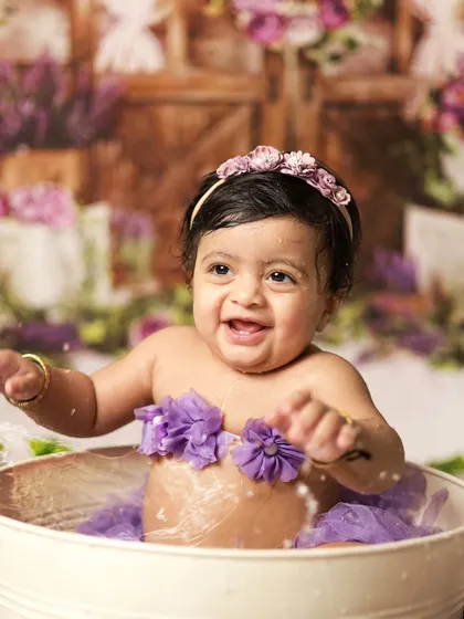 Splish, splash, having a blast! The joy on her face is priceless. Our floral-themed tub setup is perfect for these fun water play photos.