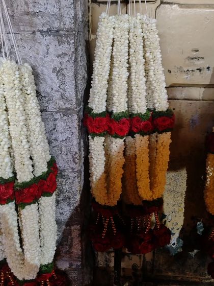 Freshly made jasmine flower garlands (gajra) ready for decorating an event space or for use in ceremonies.