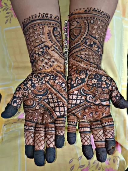 A classic semi-bridal look with a mix of paisleys, checks, and floral patterns. The dark, bold application ensures the design stands out beautifully.