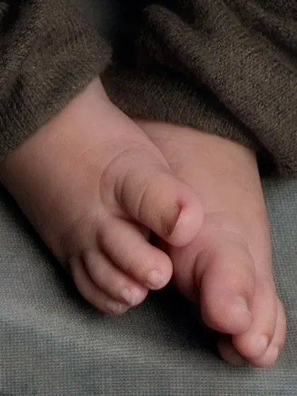 A macro detail shot focusing on the tiny, perfect toes of a newborn. We believe in capturing every little detail, as these are the features that change so quickly.