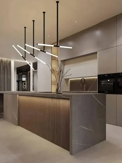 We design sleek, modern modular kitchens that are both beautiful and highly functional. This kitchen features a minimalist aesthetic with handleless cabinets, an elegant island with fluted paneling, and integrated appliances, all built with premium, durable materials.