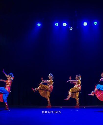 A group of my students in a synchronized high-kick pose at the 'SADHANA Dance Festival', showcasing their strength, flexibility, and coordination.