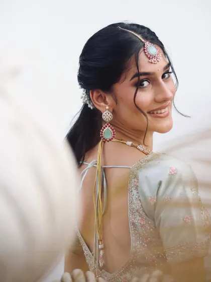 A stunning engagement bridal inspiration shot, with a focus on the beautiful smile and pastel lehenga.