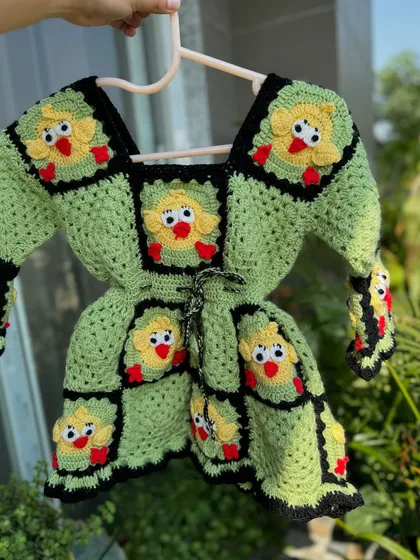 A full dress version of our duck-themed design. This adorable granny square dress is perfect for little ones who love animals, combining warmth with a fun, quirky style.
