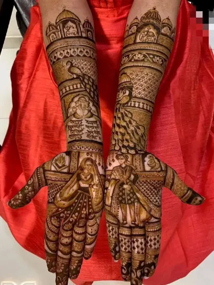 This design features the bride and groom on opposite hands, creating a complete picture when brought together. The arms include peacocks and palace architecture.