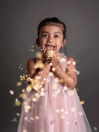 Letting a child's personality shine through is pure joy. A little bit of glitter and a big smile make for a magical kid's portrait that captures her sparkling spirit.