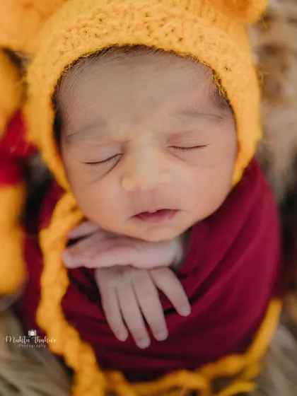 A close-up of our sleepy Pooh bear. Capturing these peaceful moments during the first few weeks is what newborn photography is all about.