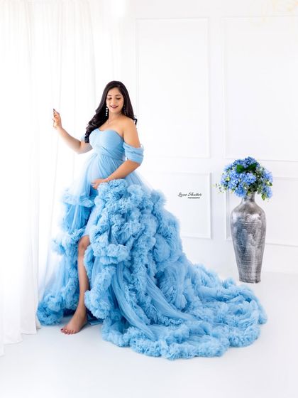 Blooming beautifully in blue. This high-key studio shot with a bright white background makes the blue gown pop.