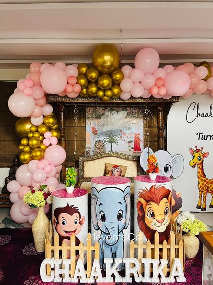 A closer look at the jungle animal pedestals and the pink and gold balloon arch. This setup is great for naming ceremonies or first birthdays.