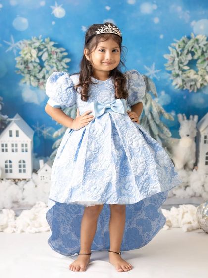 A little girl dressed as Princess Elsa in a magical winter wonderland. This theme is a favorite for Christmas and holiday mini sessions.