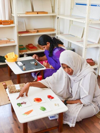 The sacred practice of Montessori learning. This image shows our adult learners deeply focused on their work with materials. Before guiding a child, our educators immerse themselves in every detail, embodying the lesson to become a prepared and soulful guide.