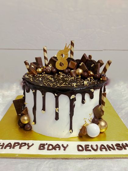 A delicious vanilla cake loaded with chocolate bars, wafers, and Ferrero Rocher.