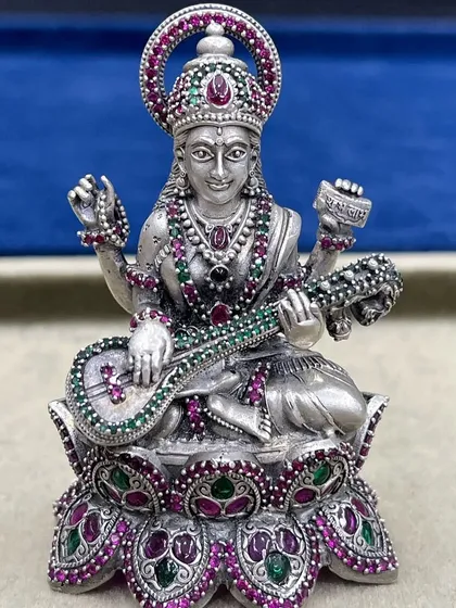 Our beautiful Goddess Saraswati idol in 925 silver, holding the veena. The colourful stones add a touch of elegance, making it a perfect gift for students or artists seeking blessings for knowledge and creativity.
