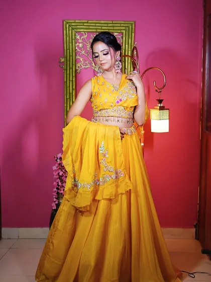 A full-length pose showing the complete Haldi look with its unique dupatta drape.
