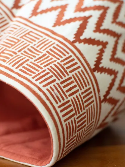 A closer look at the details reveals the quality of our block-printed baskets. The crisp geometric pattern is printed on sturdy fabric, and the interior is lined to ensure it holds its shape, whether holding a plant or your favorite books.